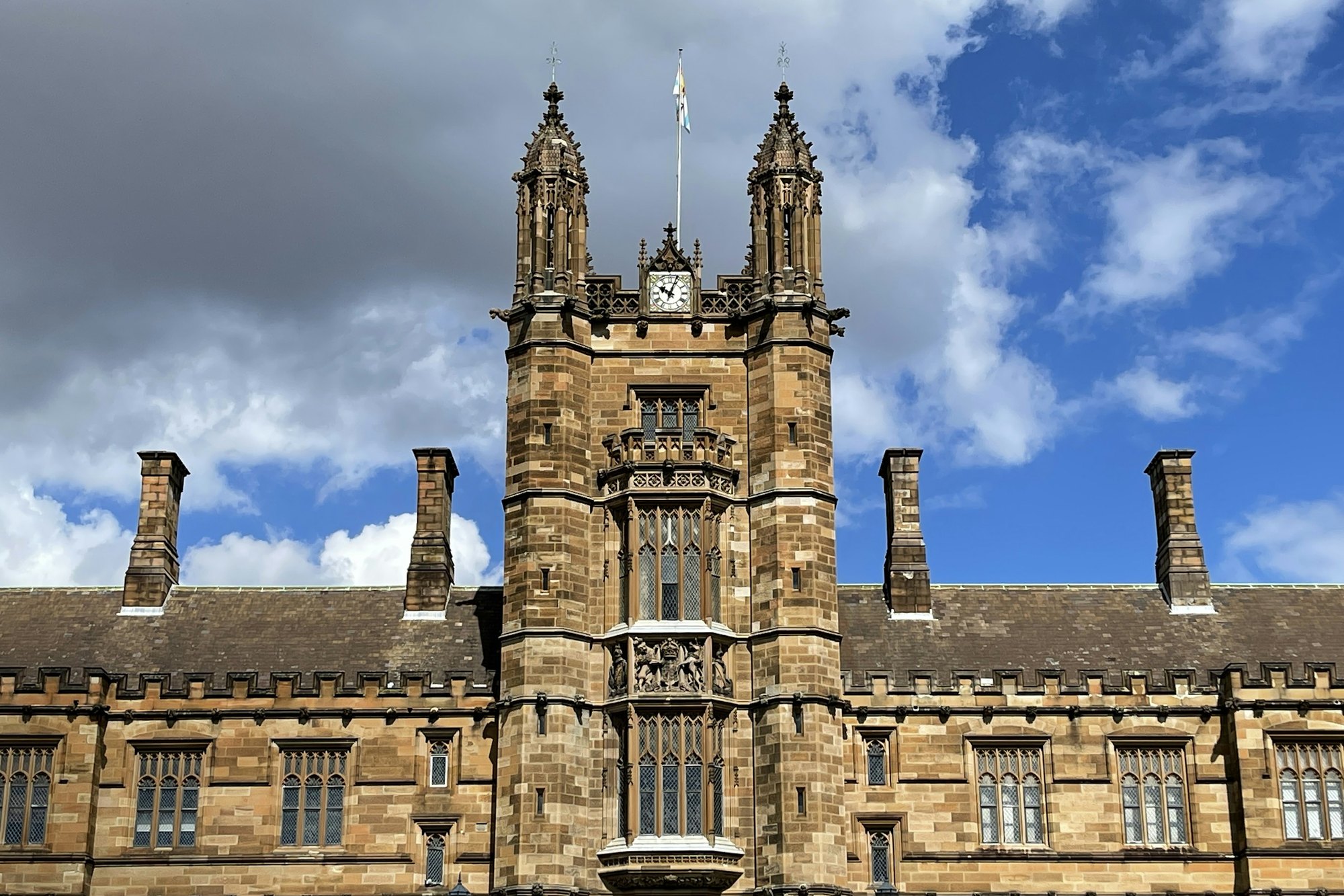 A sandstone university clock tower