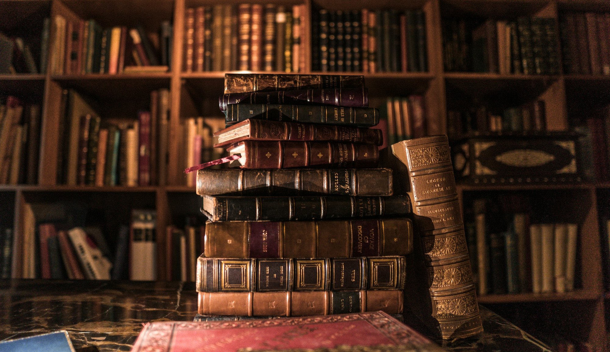 Old books stacked on a library shelf